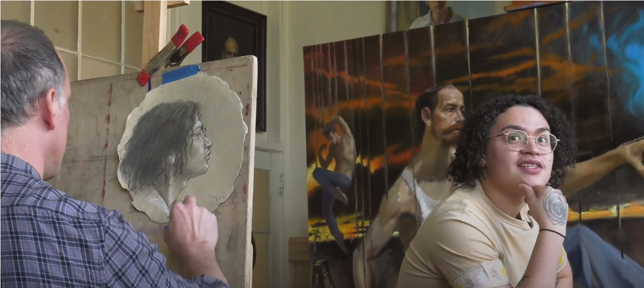 Man drawing a portrait of a young man